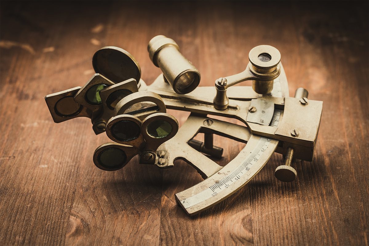Brass sextant on a wooden table