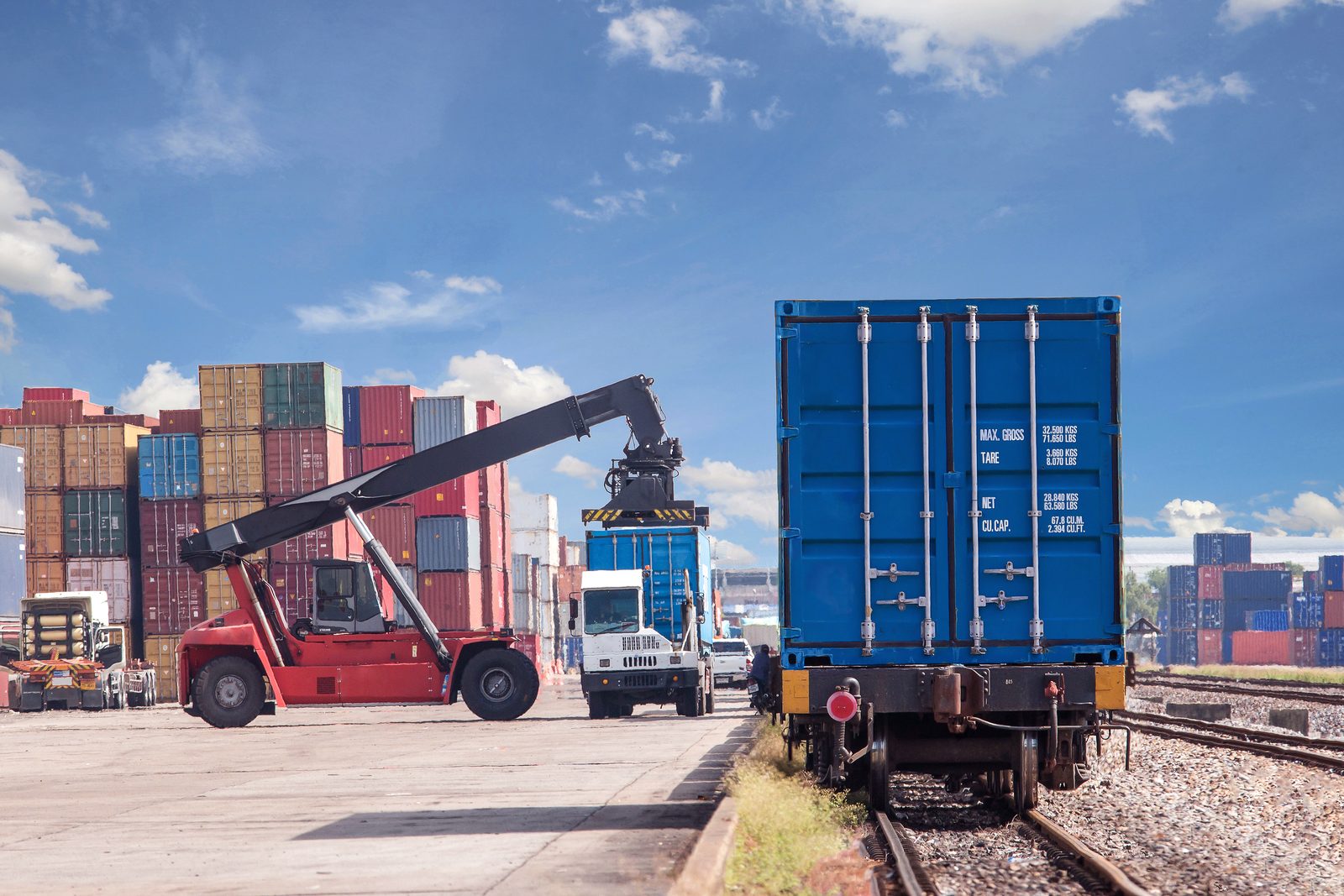 Container handler loading freight at a rail terminal